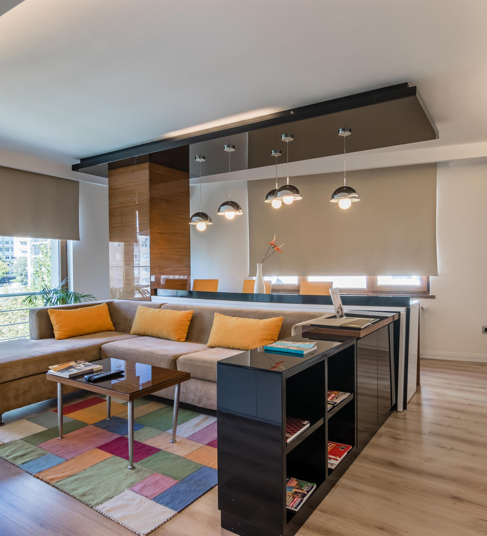 Open-plan living area with kitchen island in an 80 square metre apartment