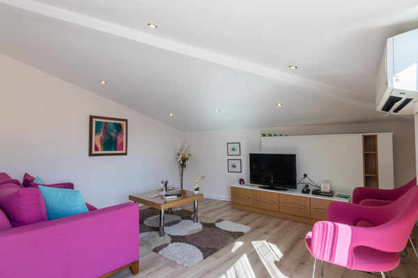 Penthouse living room with television and seating
